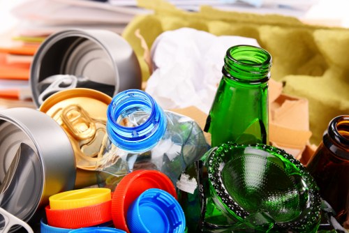 Sorted recyclable materials including paper, glass and food caddies in a commercial setting
